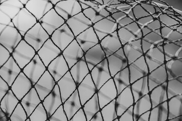 Fishing net as a background for fishing black and white photo