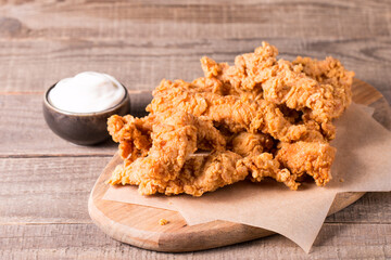 Crispy fried chicken breast strips with sauce