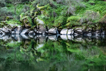Fototapeta na wymiar Rocks with river reflections