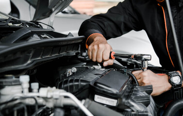 Mechanic fixing a car at home. Repair and service.