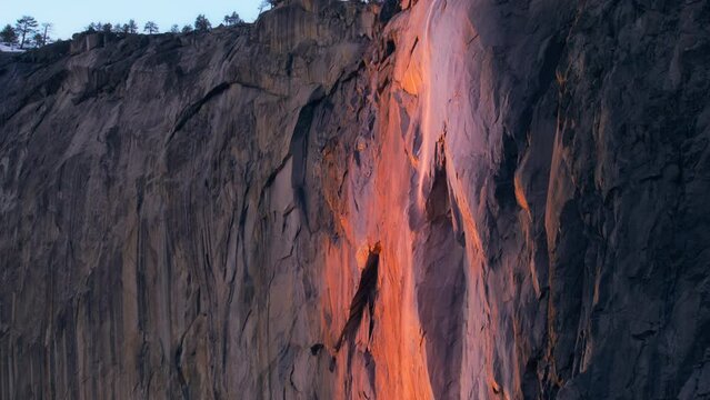 Scenic view of Yosemite Firefall lighting by sunset sun, Yosemite National Park, California, USA. Wonderful Horsetail fall in evening time. Natural background with copy space. Panning shot in 4k 