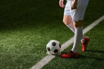 sports girl football player with a soccer ball on the soccer field, the concept of professional women's football