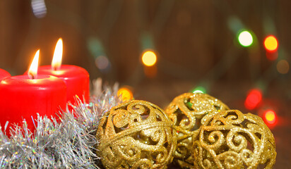 three burning candles and golden balls. Christmas still life