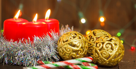 three burning candles and golden balls. Christmas still life