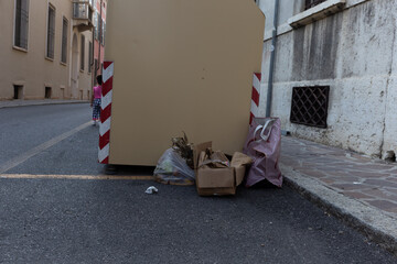 Waste dumped near dumpsters, showcasing environmental negligence and improper disposal habits. This...