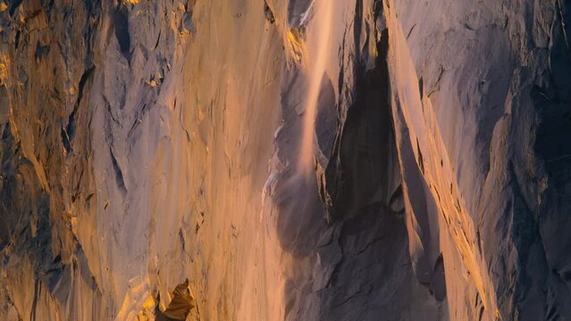 Colorful sunset lights illuminated Horsetail fall in Yosemite National Park, California, USA. Panning shot shot of Breathtaking landscape of Yosemite Firefall in Yosemite valley in evening, 4k footage