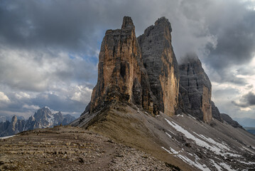 Sideview of the cloud covered cliffs of the Tre Cime di Lavaredo in the Dolomites, Italy