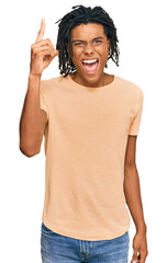 Young african american man wearing casual clothes pointing finger up with successful idea. exited...