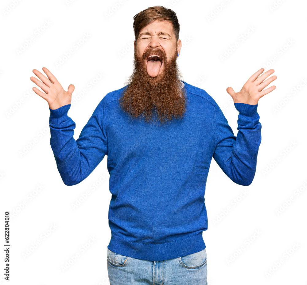 Poster young irish redhead man wearing casual clothes celebrating mad and crazy for success with arms raise