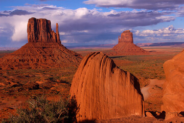 Fading sunlight illuminates rock formations in Monument Valley