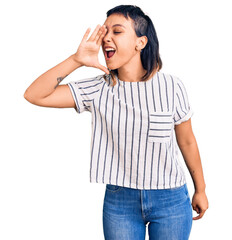 Young woman wearing casual clothes shouting and screaming loud to side with hand on mouth. communication concept.