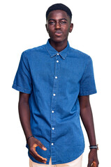 Fototapeta premium Young african american man wearing casual clothes looking at the camera blowing a kiss on air being lovely and sexy. love expression.