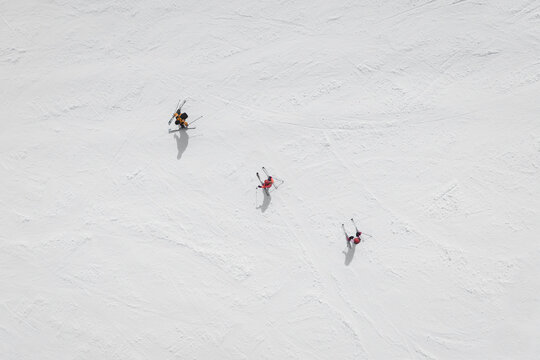 Aerial view of three skiers in a row on Mount Etna, Sicily, Italy.