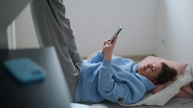 Woman reads e-book in her cozy apartment, 4k