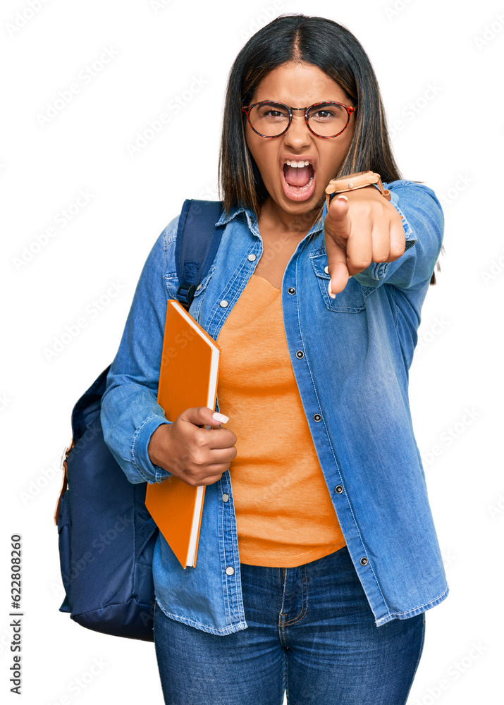 Poster young latin girl wearing student backpack and holding books pointing displeased and frustrated to th