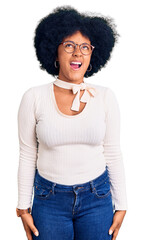 Young african american girl wearing casual clothes and glasses angry and mad screaming frustrated and furious, shouting with anger. rage and aggressive concept.