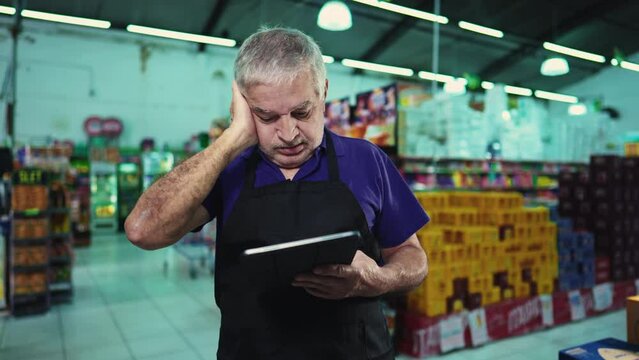 Stressed business owner of supermarket chain feeling pressure facing difficulties in grocery store operations. Portrait of a frustrated manager with unshaven beard and gray hair