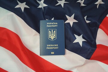 Ukrainian passport on the background of the American flag, Ukraine, America, Foreign relations, politics