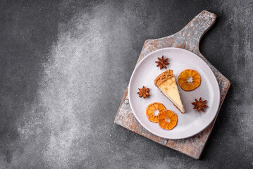 Delicious sweet cheesecake cake on textured concrete background