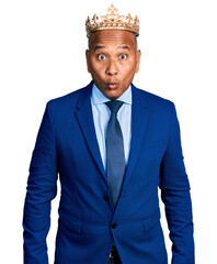 Hispanic middle age man wearing king crown scared and amazed with open mouth for surprise, disbelief face