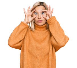 Middle age caucasian woman wearing casual winter sweater trying to open eyes with fingers, sleepy and tired for morning fatigue