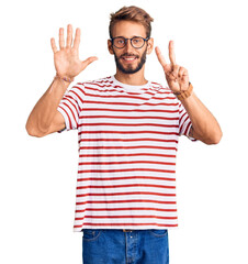 Handsome blond man with beard wearing casual clothes and glasses showing and pointing up with fingers number seven while smiling confident and happy.