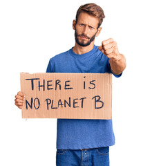 Handsome blond man with beard holding there is no planet b banner annoyed and frustrated shouting with anger, yelling crazy with anger and hand raised
