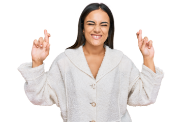 Young brunette woman wearing casual clothes gesturing finger crossed smiling with hope and eyes closed. luck and superstitious concept.