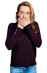 Young caucasian woman wearing casual clothes shocked covering mouth with hands for mistake. secret concept.