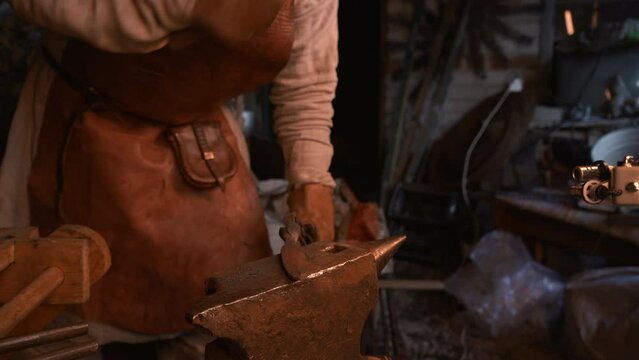 Turning iron. Media. Processionals work to shape the iron in with special hammers.
