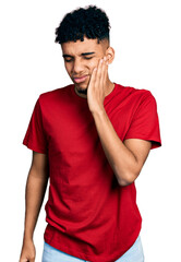 Young african american man wearing casual red t shirt touching mouth with hand with painful expression because of toothache or dental illness on teeth. dentist