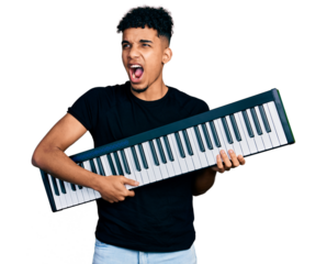 Young african american man holding piano keyboard angry and mad screaming frustrated and furious, shouting with anger. rage and aggressive concept.