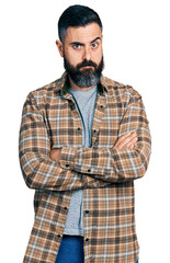Hispanic man with beard with arms crossed gesture skeptic and nervous, frowning upset because of problem. negative person.