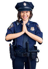 Young beautiful girl wearing police uniform praying with hands together asking for forgiveness smiling confident.