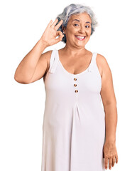 Senior woman with gray hair wearing casual clothes smiling positive doing ok sign with hand and fingers. successful expression.