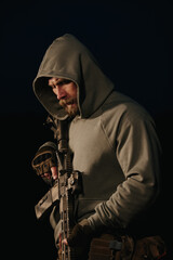 Naklejka premium Ukrainian defender with his weapon on a black background