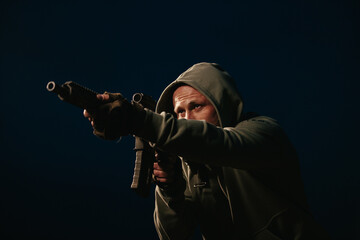 Male Ukrainian defender aiming his rifle at night