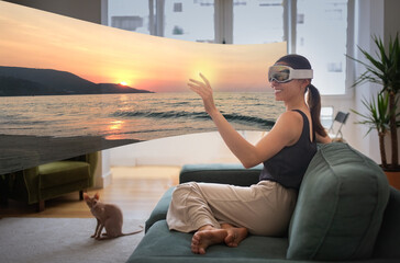 Woman In VR Glasses Touching Digital Screen Sitting At Home