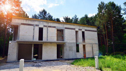 Single modern house under construction. A building on the edge of the forest.