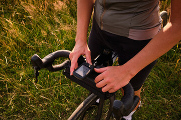 Cyclist using a bike computer close-up photo.Bike navigator.Cycling computer.