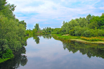 Landscape with river in summer. River landscape with white clouds