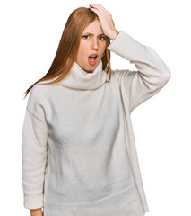 Young irish woman wearing casual winter sweater surprised with hand on head for mistake, remember...