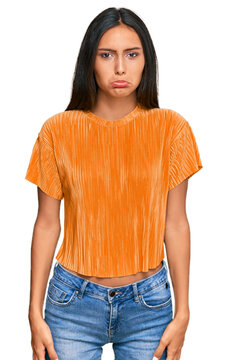 Young brunette arab woman wearing casual clothes depressed and worry for distress, crying angry and afraid. sad expression.