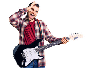 Young handsome man playing electric guitar smiling happy doing ok sign with hand on eye looking through fingers
