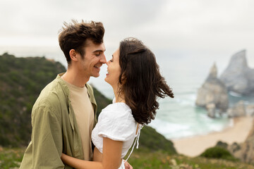 Coastal connection. Happy young couple embracing and bonding, enjoying date on coastline, copy space