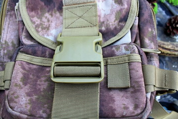 Equipment for outdoor travel on camouflage fabric with branches of coniferous trees