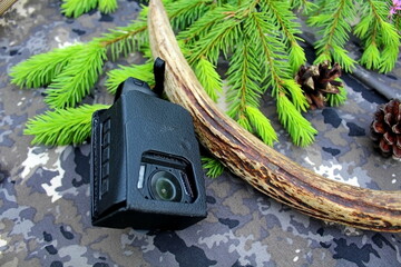 Traveler's and nature lover's accessories on camouflage material	