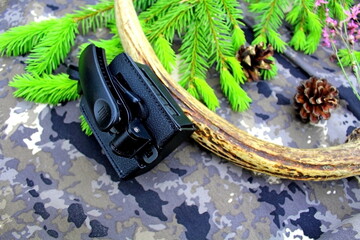 Traveler's and nature lover's accessories on camouflage material	