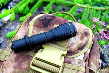 Traveler's and nature lover's accessories on camouflage material	