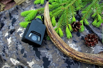 Traveler's and nature lover's accessories on camouflage material
